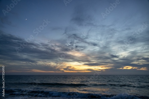 Scenic view of sea waves against Zuma Beach at sunset photo