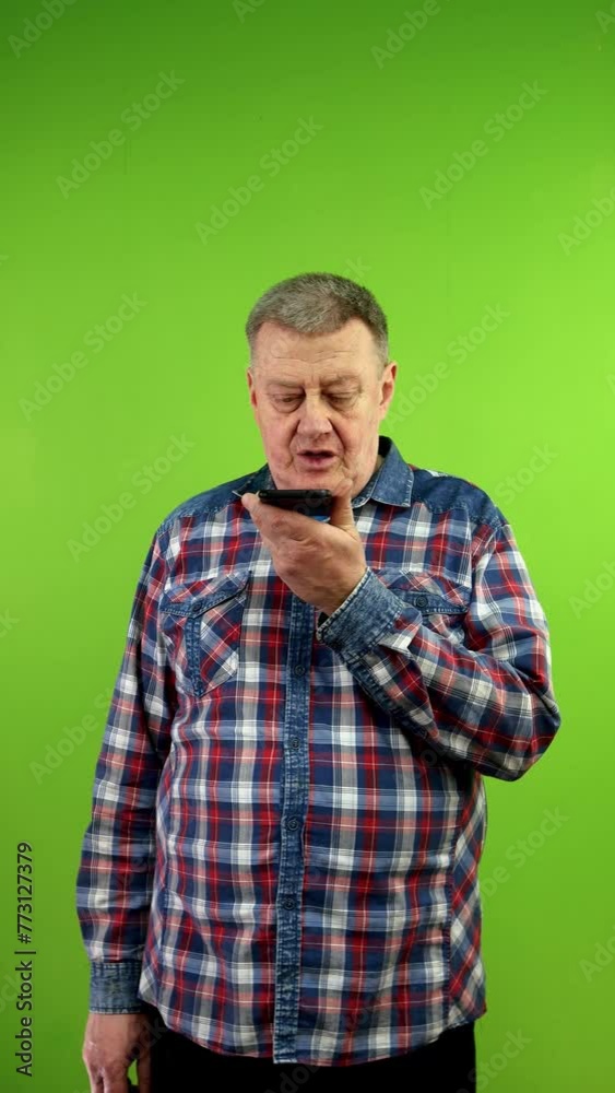 Man records voice message with on speakerphone. Man records voice message with on speakerphone.