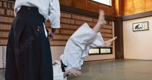 Woman, sensei and aikido fight for training, fitness and challenge with action, exercise and coaching. Teaching, learning and student in traditional Japanese martial arts class with aikidoka.