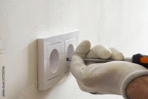Installation of electric household socket on the wall during the renovation of the apartment © woff