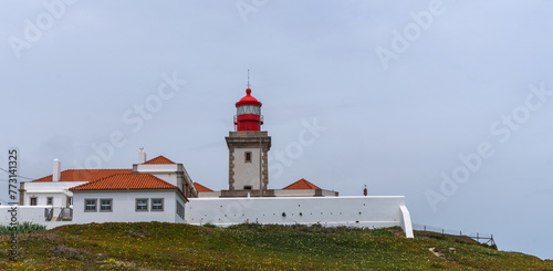 View of the Atlantic coast near the lighthouse in Cabo da Roca in Portugal. The westernmost point in Europe. Flowering spring coastal plants. photo