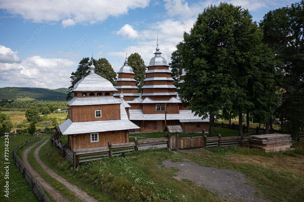 Aerial view on ancient wooden Church of Synaxis of the Holy Mother of God in Matkiv, Lviv region, Ukraine from drone