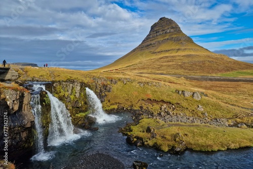 Kirkjufell mountain with a magnetic waterfall in the foreground  Iceland