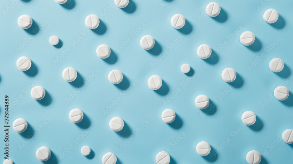 White round pills are evenly spaced on a blue background.