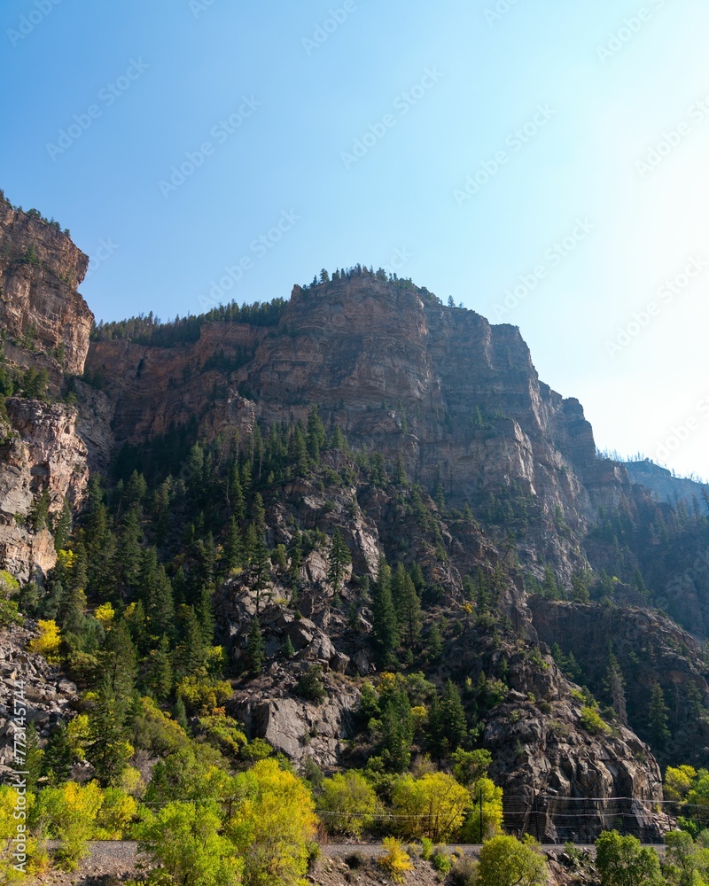 Bright and sunny day with a picturesque landscape of rocky cliffs and lush green trees
