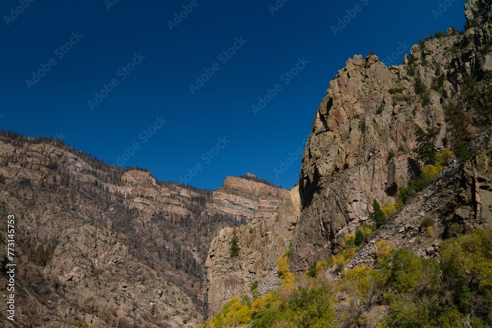 Bright and sunny day with a picturesque landscape of rocky cliffs and lush green trees