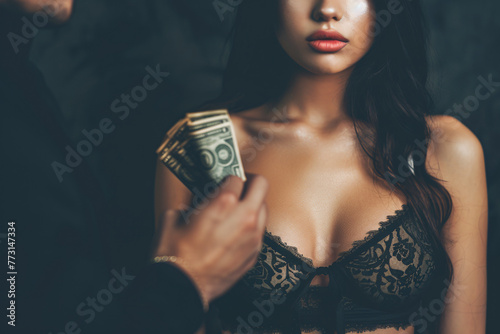 escort and prostitution concept - sexy woman in lingerie taking money from male client photo