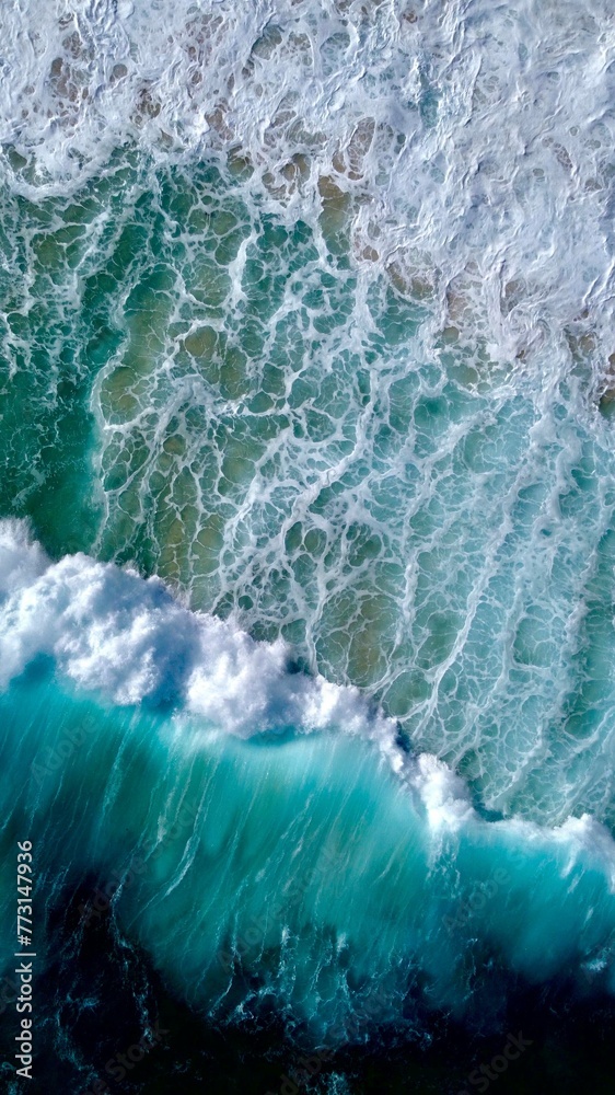 Fototapeta premium Aerial view of a sandy beach against the sea on a sunny day