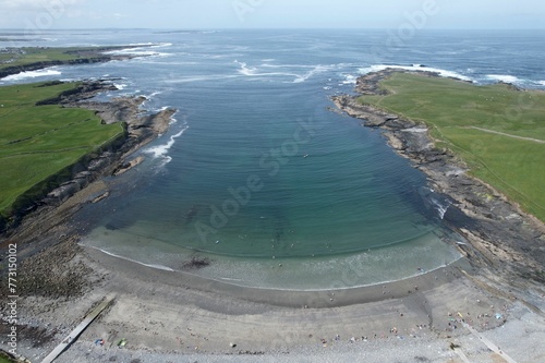 View of a tranquil shoreline of Whitestrand, Miltown Malbay on a sunny day photo