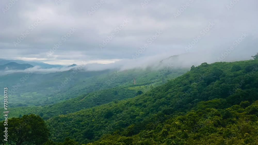 Beautiful view of foggy clouds moving over green landscapes Beautiful view of foggy clouds moving over green landscapes