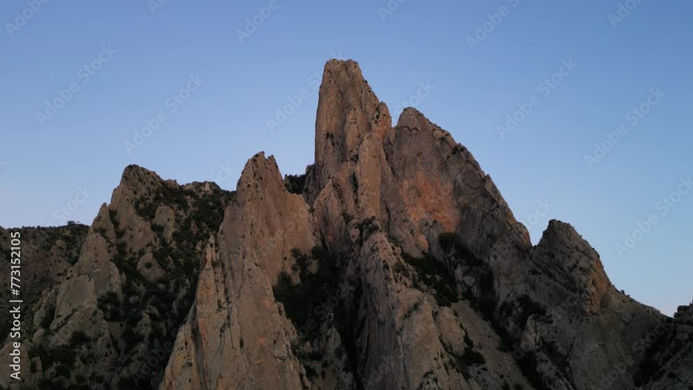 Landscape view of rocky formation mountain with purple sunset sky on the horizon Landscape view of rocky formation mountain with purple sunset sky on the horizon