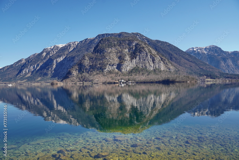 Picturesque view of the lake with the reflection of the rocky mountain, Hallstatt, Austria.