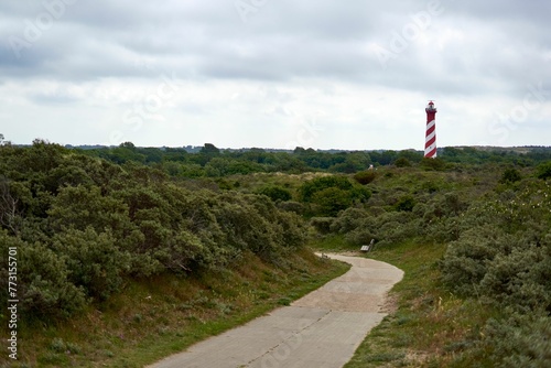 the path is winding along the coast side and has several signs on it