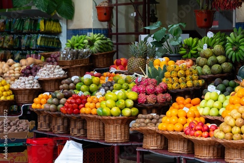 fruits are in baskets and stacked next to each other at an outdoor market © Wirestock