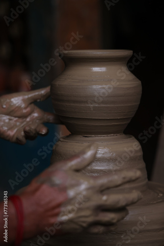 The potter works on a pottery wheel to made of soft colored clay, retro style toned Clay pots with hand and equipment