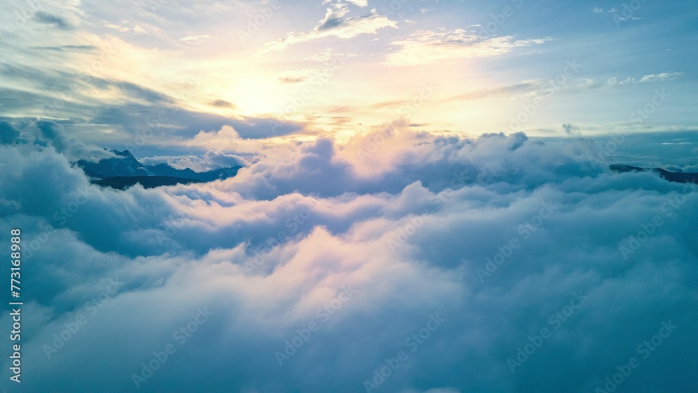 Aerial shot of clouds over the mountains in Yunnan province, China. - obrazy, fototapety, plakaty 
