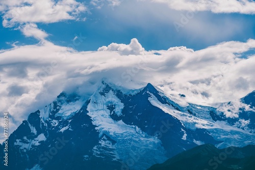 Beautiful view of a cloudy sky over the Meili Snow Mountains in the Chinese province of Yunnan. © Wirestock