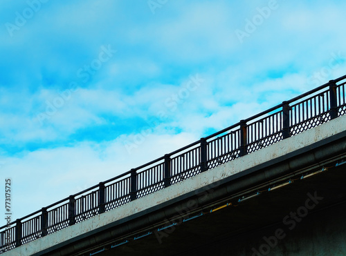 Diagonal bridge fencing under the daylight clouds background