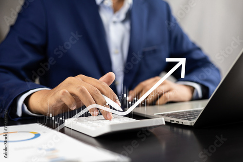 Businessman using tablet and laptop analyzing sales data economic growth graph chart strategic approach to success, Utilizing technology for financial growth analysis business, Investment insights.