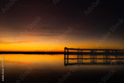 Captivating sunset scenery unfolds at The Rio Tinto Pier (Muelle de Rio Tinto) in Huelva, Andalusia, Spain © SylviePM