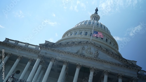 Fotografija Angle view of the US Capitol dome with flag at half mast feeling chaos, tilted angle, seat of government in Washington, DC on a beautiful sunny day with clear blue sky