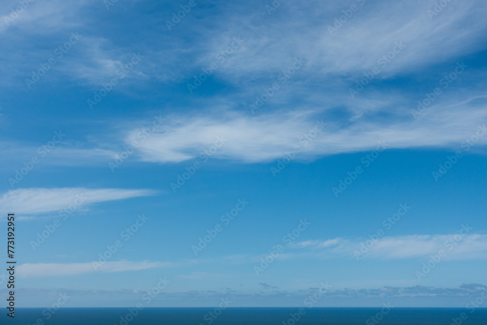 Blue sky with the horizon line and ocean