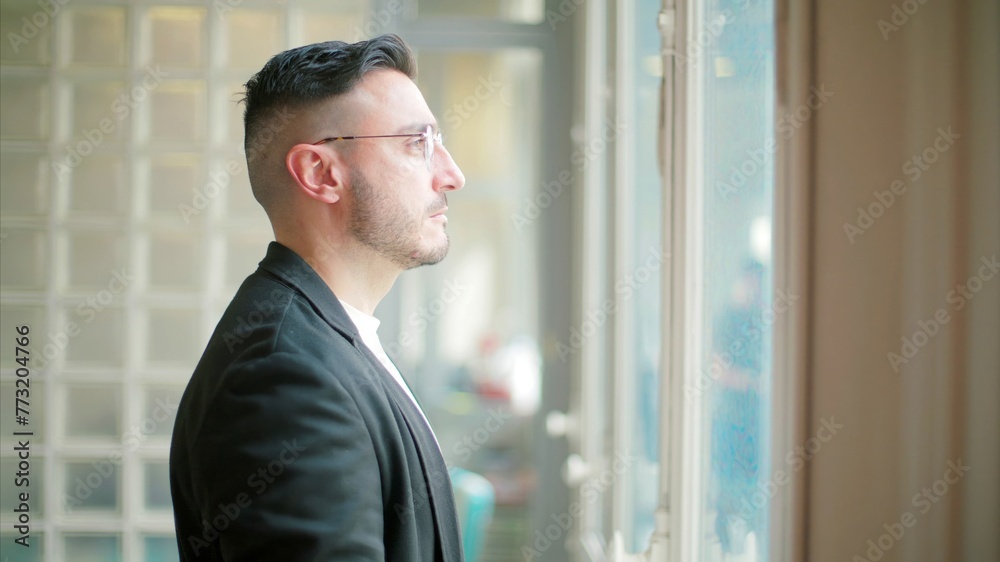 Fototapeta premium Pensive man by glass block window