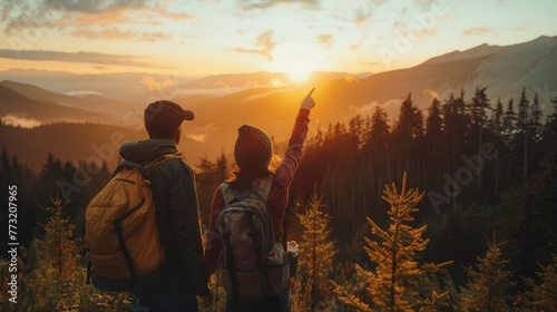 During sunset, an adventurous couple examines a beautiful landscape and points to the mountains in Washington, East of Vancouver and Seattle.