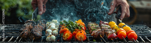 Outdoor grilling of various meats and vegetables, releasing savory smoke on a barbecue grill. photo