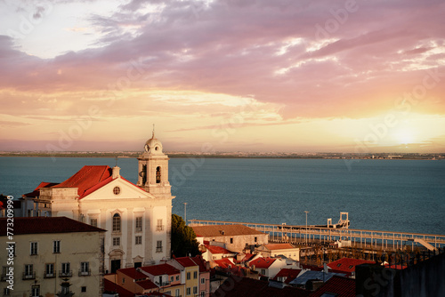 Beutiful view of old town in Lisbon. Red tiled roofs and blue river.