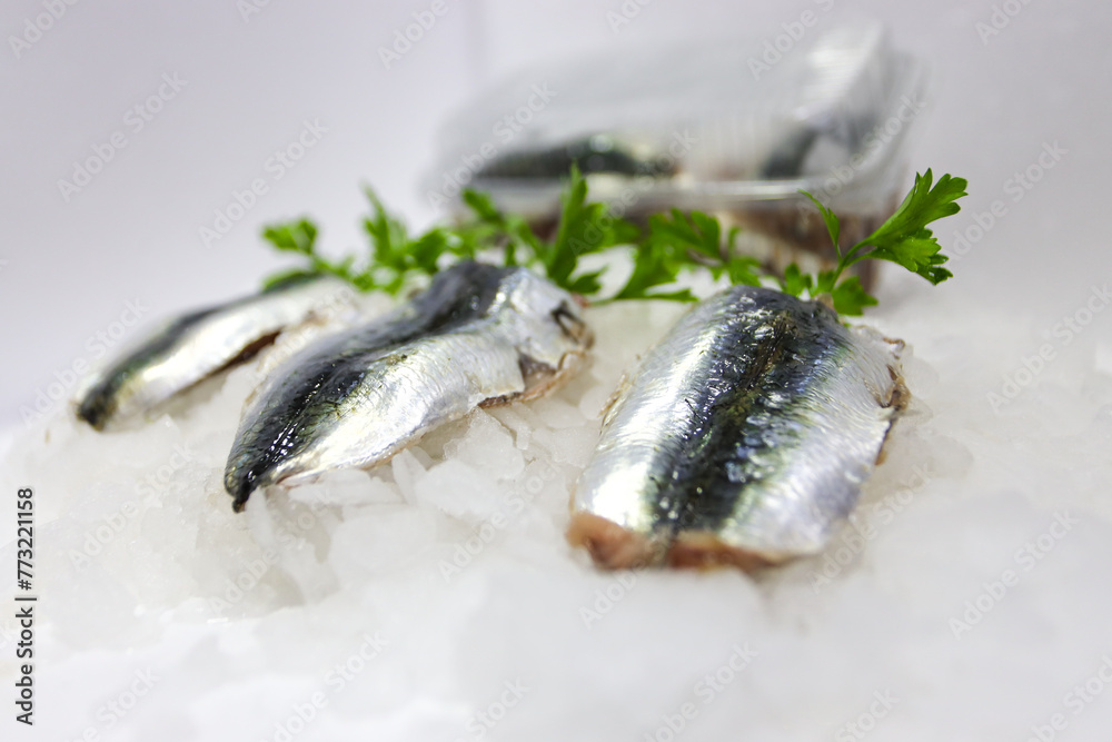 Raw sardine fillets on ice