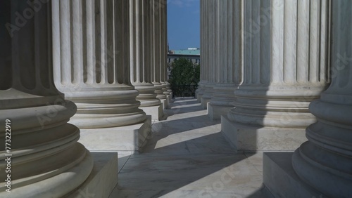Very large towering columns in front of US Supreme Court building in Washington, DC showing judicial power over people and business.
