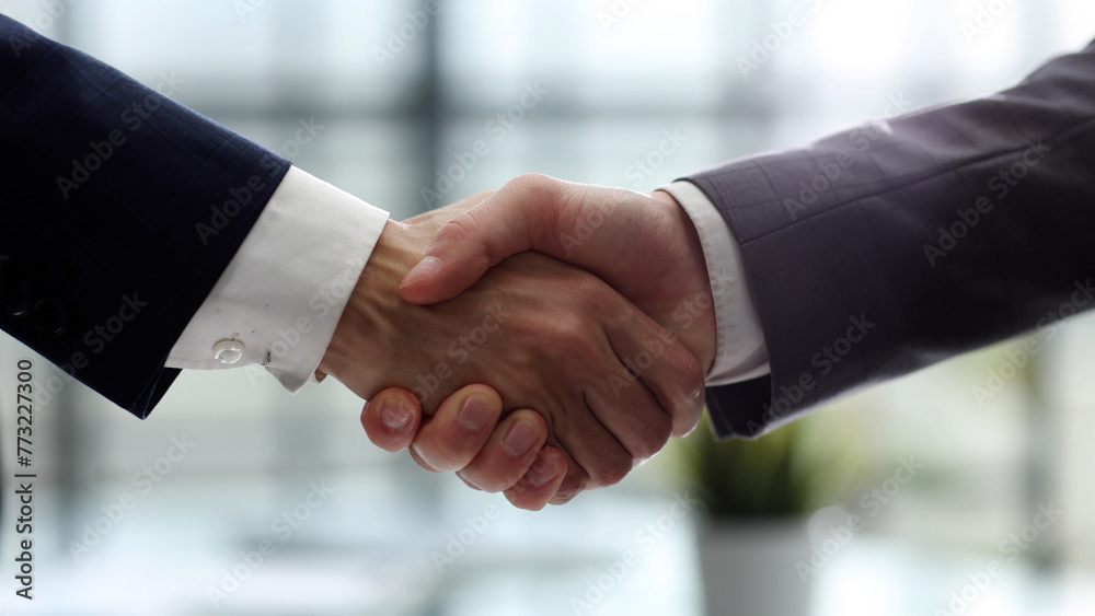 Two men shaking hands in a business setting