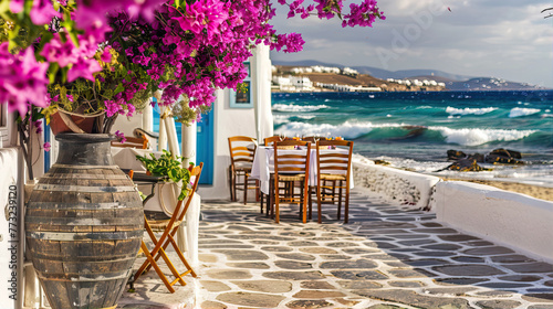 Tree with pink flowers and houses by the sea on the island of Santorini 