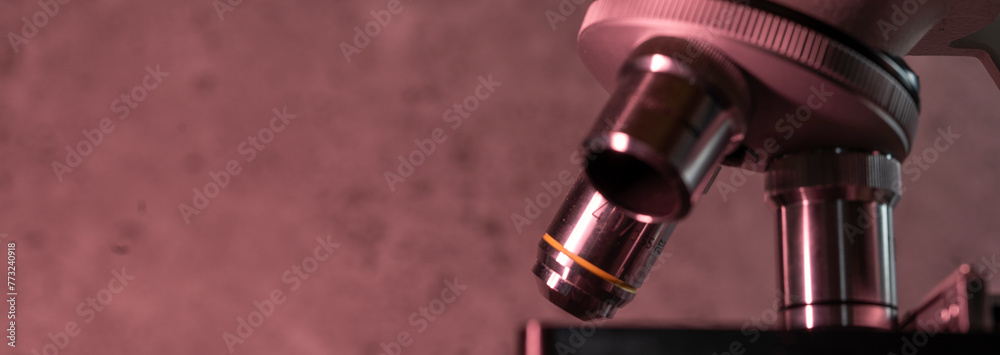 Medical microscope lenses close up, In warm red lighting Medical microscope lenses close up, In warm red lighting