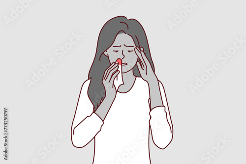 Bleeding from nose of sick woman holding handkerchief with blood stains, caused by high intracranial pressure. Upset girl in casual t-shirt needs medications to lower intracranial pressure