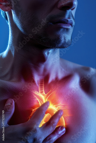 A man is holding his chest and his heart is red. Concept of pain and discomfort, as the man is likely experiencing a heart attack or some other heart-related issue © Mongkol