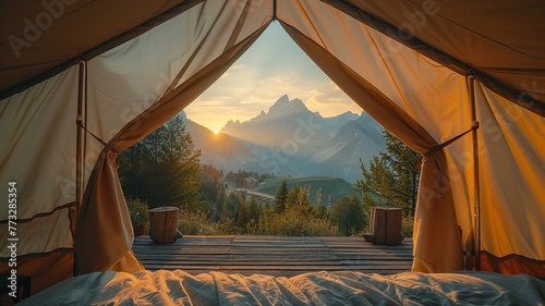 Majestic peaks framed by a glamping tent at sunrise