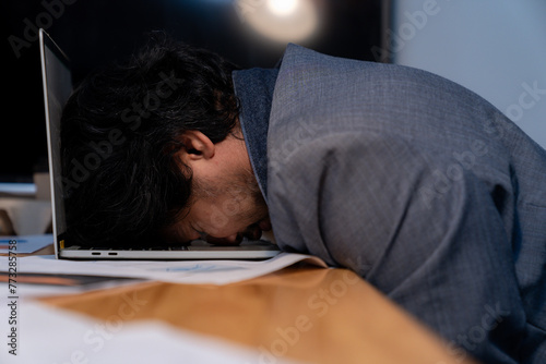 The man who worked late fell asleep with his laptop still at work