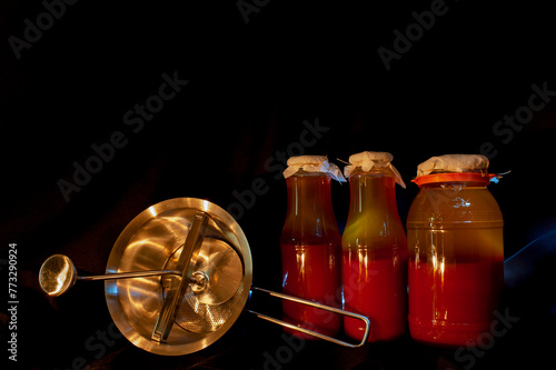 Tomato juice in glass jars. Traditional red sauce recipe. Saving the crop. Country food. ketchup, prepared at home.