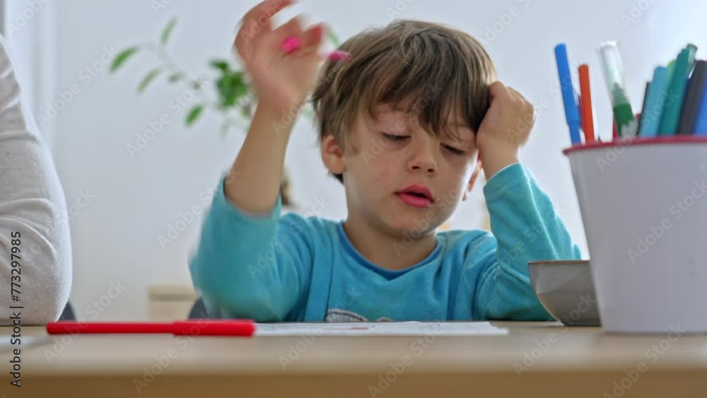 Little Boy Takes Thoughtful Break From Homework While Snacking Little Boy Takes Thoughtful Break From Homework While Snacking