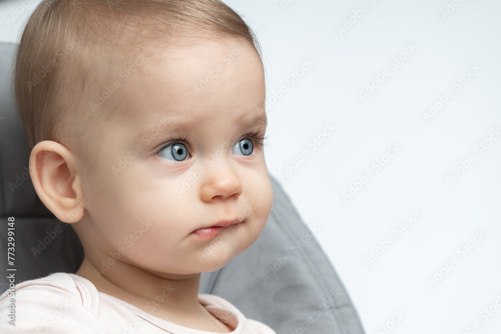 Baby's thoughtful expression caught in a close-up. Concept of early contemplation and the depth of young minds Baby's thoughtful expression caught in a close-up. Concept of early contemplation and the depth of young minds