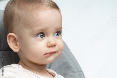 Baby's thoughtful expression caught in a close-up. Concept of early contemplation and the depth of young minds
