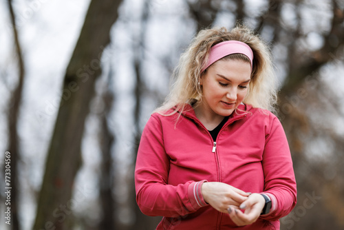 Woman Preparing for Outdoor Training and Checking Her Smartwatch
