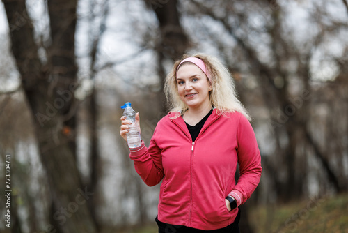Woman Holding Water Bottle - Hydration and Health Concept