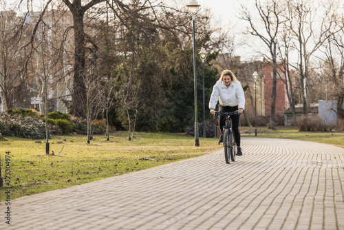 Woman Riding Bicycle Down Brick Road in the Park