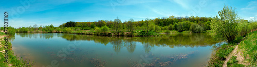 Panoramic view of a calm lake on a sunny summer day