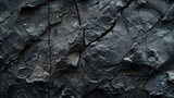 Black white rock background. Dark gray stone texture. Mountain surface close-up. Distressed, сracked, collapsed, crumbled, broken.