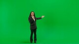 Young female reporter isolated on chroma key green screen background. Full shot african american woman tv news host talking in microphone.