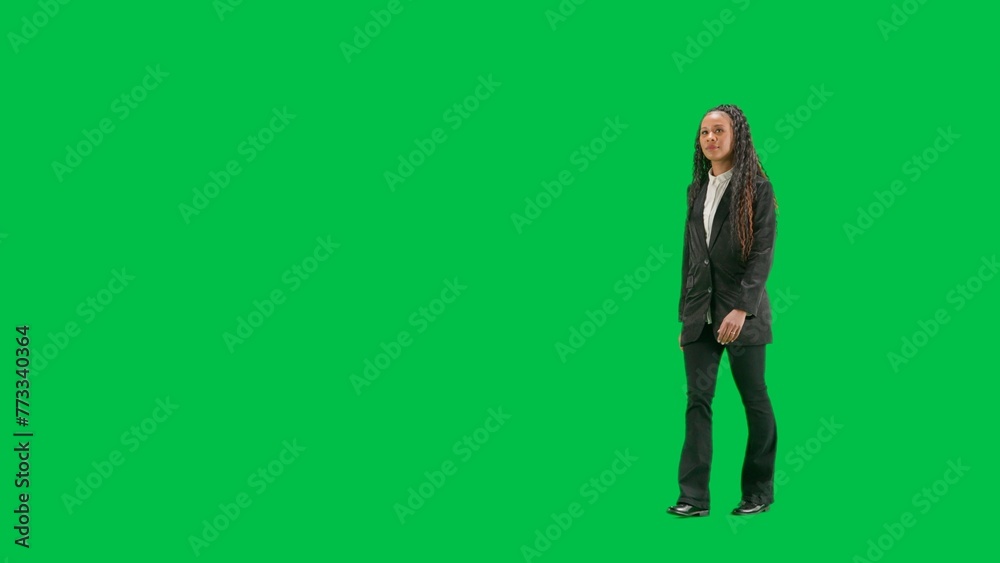 Young female reporter isolated on chroma key green screen background. Full shot african american woman tv news host walking. Half turn. Young female reporter isolated on chroma key green screen background. Full shot african american woman tv news host walking. Half turn.